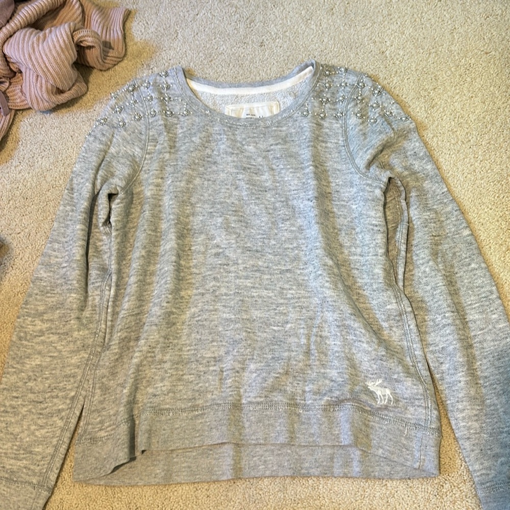 Grey sweater with detailing on shoulders